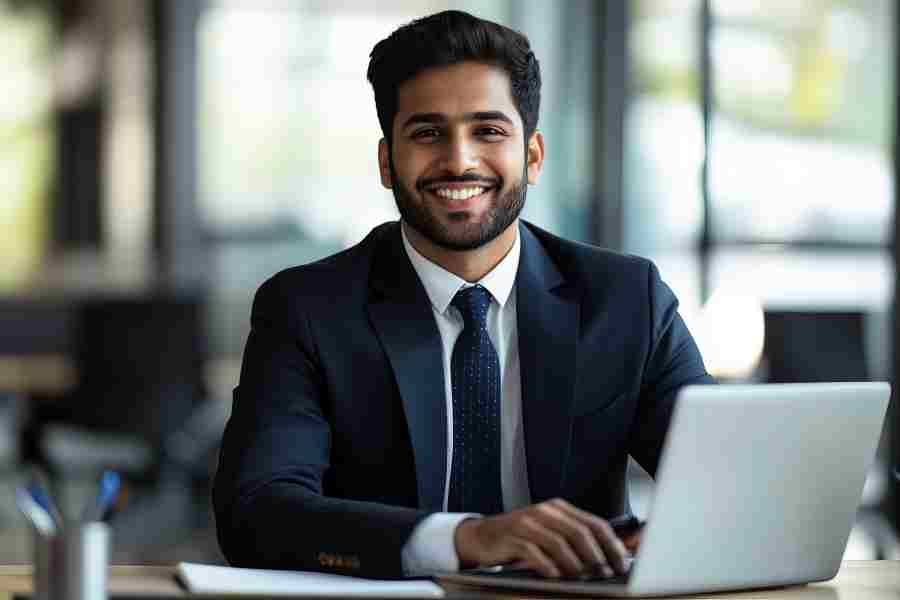 Confident successful businessman working on laptop smiling happy professional office tie desk suit
