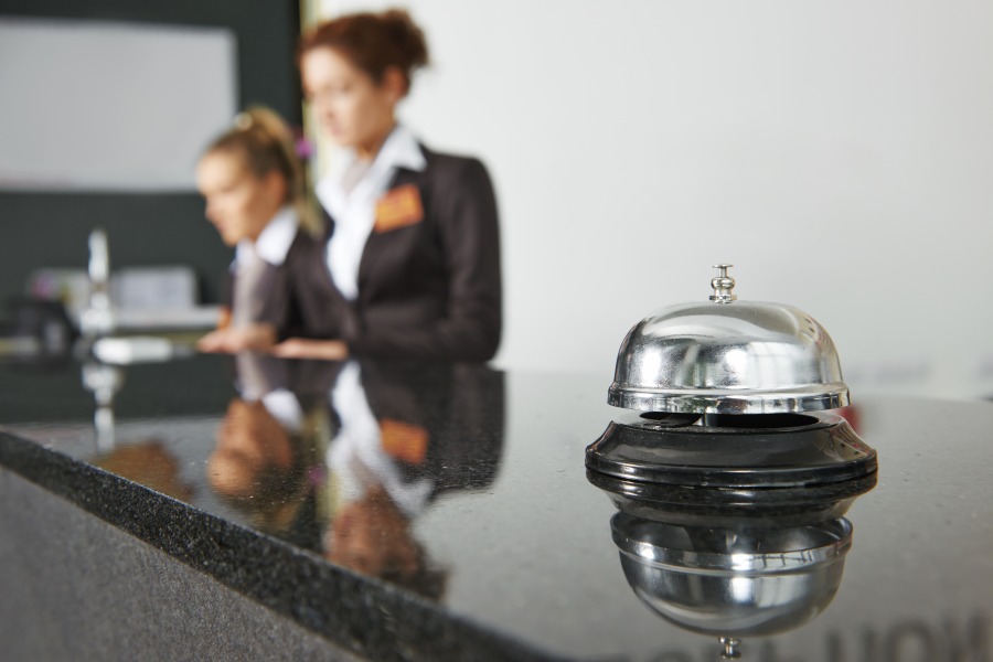 Hotel Concierge Desk with workers and bell