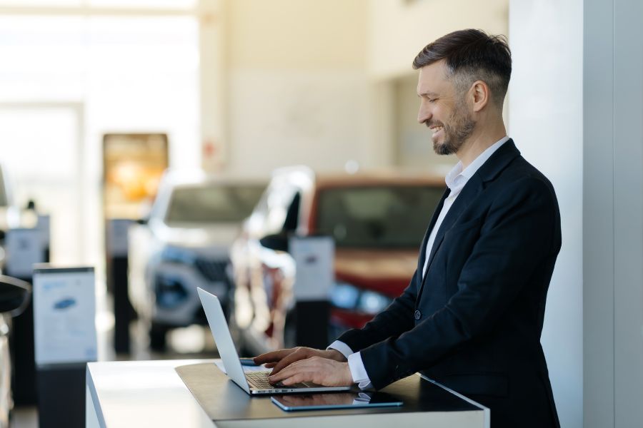 Newly Hired Leasing Consultant On His Laptop
