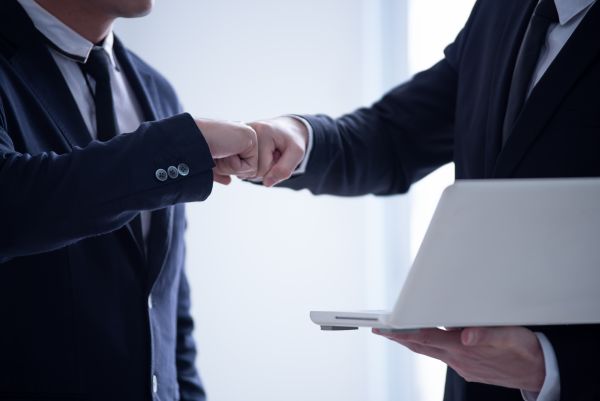 Business men fist bump