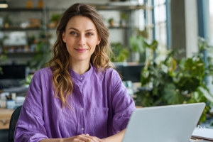 Smiling Female Emergency Employee Working on Laptop