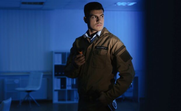 Security Guard with Portable Radio Set in Business Building After Hours