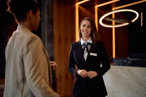 Smiling Female Concierge Communicating with Guest