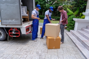 Owner Communicating with Moving Service Guys about Boxes