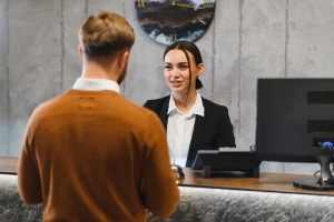 Guest Discussing Check in with Hotel Concierge at Front Desk