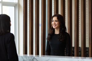 Friendly Front Desk Concierge Making Eye Contact with Guest