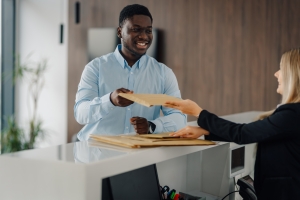 Man Handing Over A Package to Apartment Concierge
