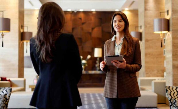 Female Concierge Assisting Resident Planning Relocation Using Tablet