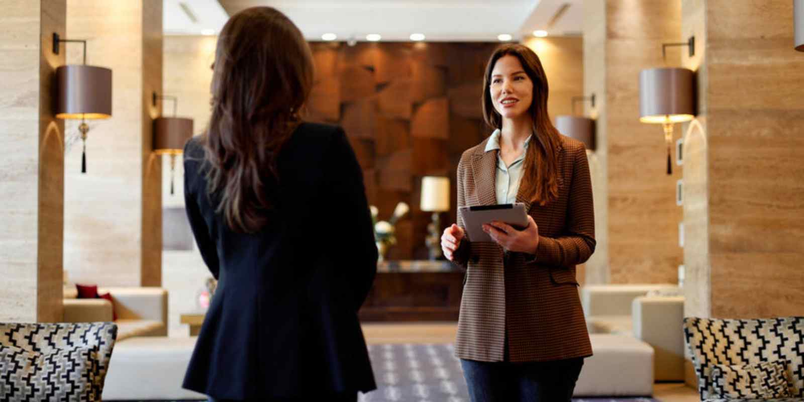 Female Concierge Assisting Resident Planning Relocation Using Tablet