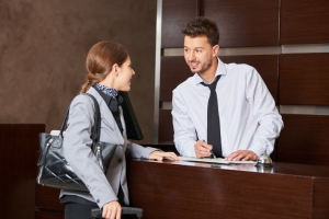 Male Concierge Helping Resident Understand Utility and Service Setup for Relocation