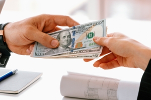 Competitive Pay Concept Through Person Giving Cash to Property Manager