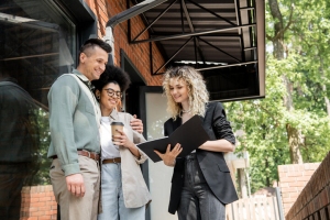Female Property Manager Talking to a Couple Near Cottage
